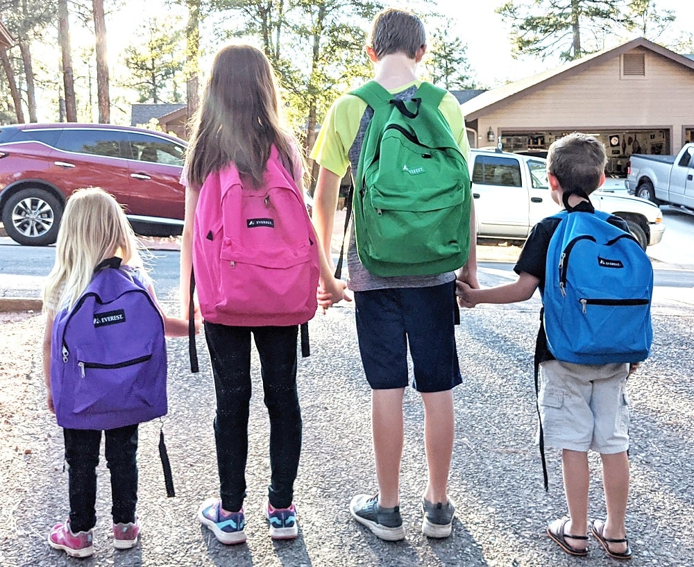 four kids with backpacks